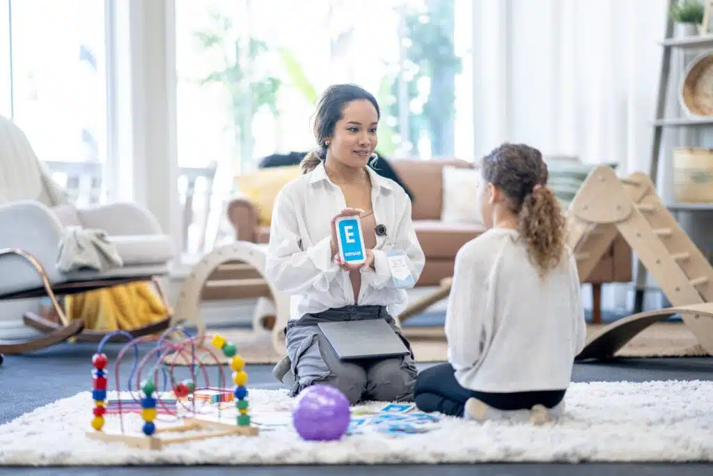 A mother and daughter playing with toys in a living room.